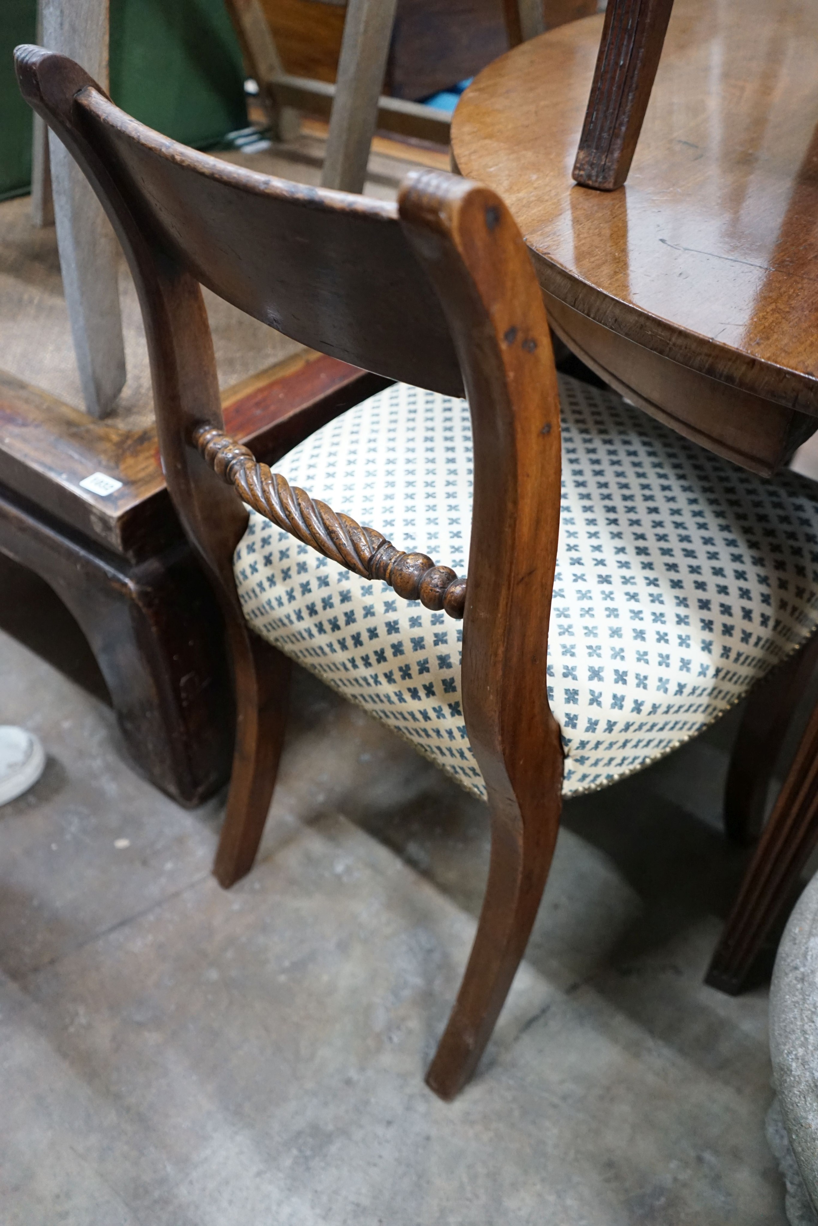 A set of six Regency sabre leg mahogany dining chairs